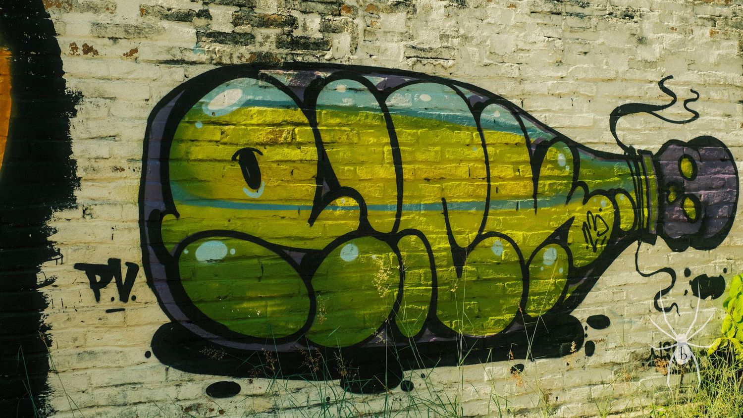 Street art graffiti depicting green bottle design on weathered wall.