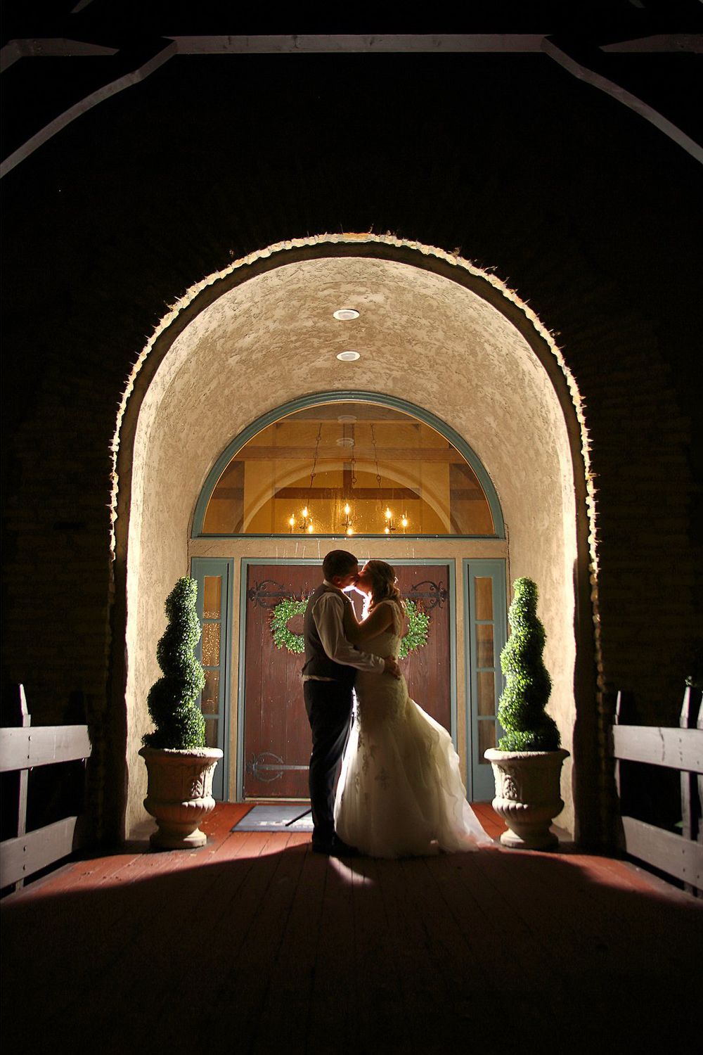 Bride and Groom silhouetted in archway at their reception at Royal American Links in Galena Ohio
