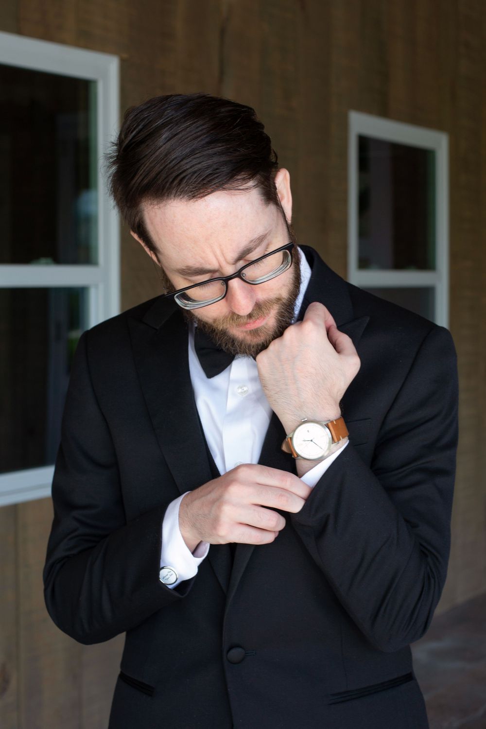 Groom fixes his cufflinks on his wedding day before seeing his beautiful bride at their first look in New Albany Ohio