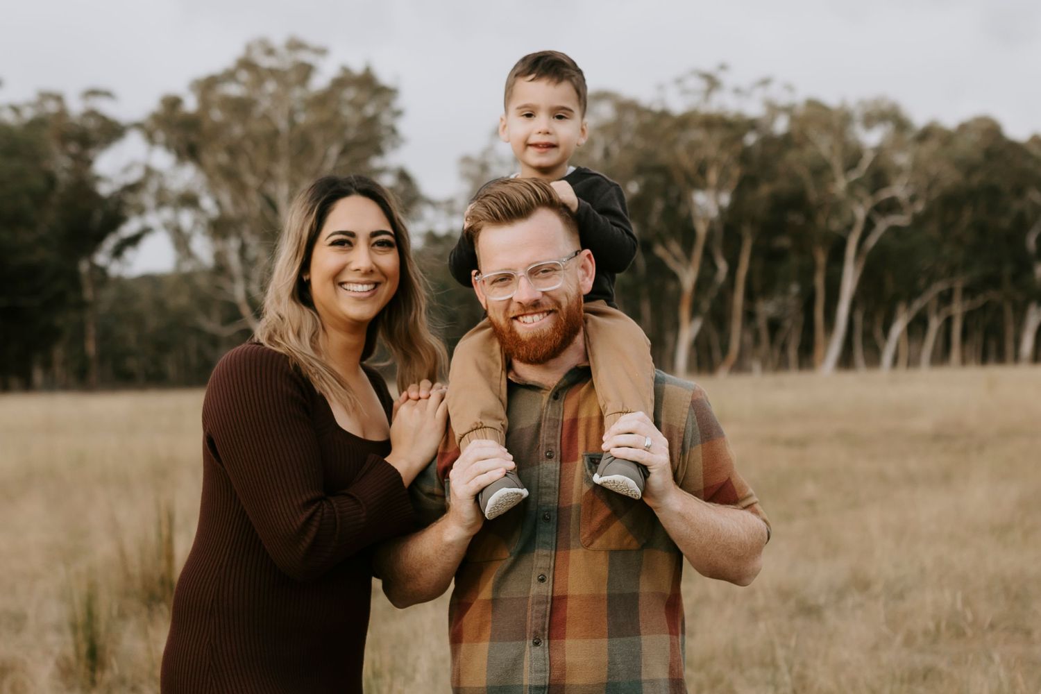 Family portrait session in outdoor natural setting during golden sunset light.
