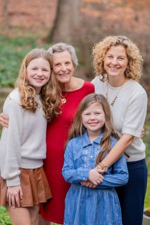 A grandmother, mother, and two daughters stand with their arms around each other in Alexandria, Virginia.