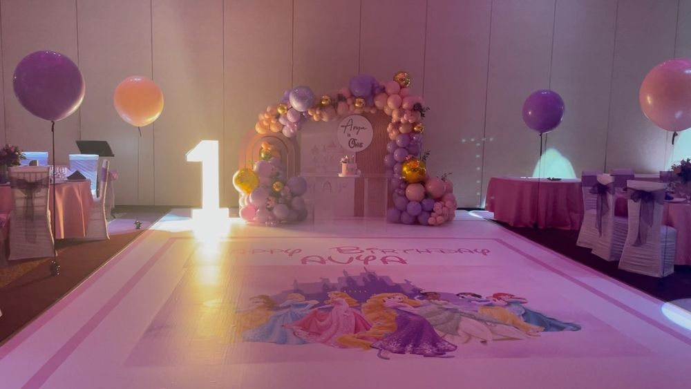First birthday banquet room set up with custom floor wrap, marquee letter 1, balloons, backdrop and floating balloons