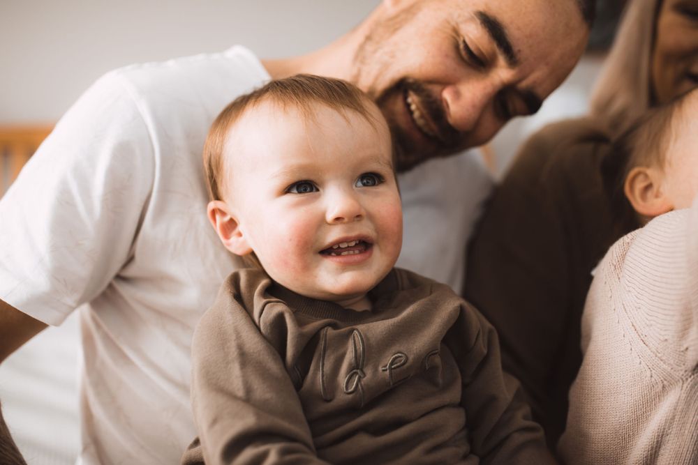 Close-up shots of a baby and parent sharing intimate bonding moments indoors.