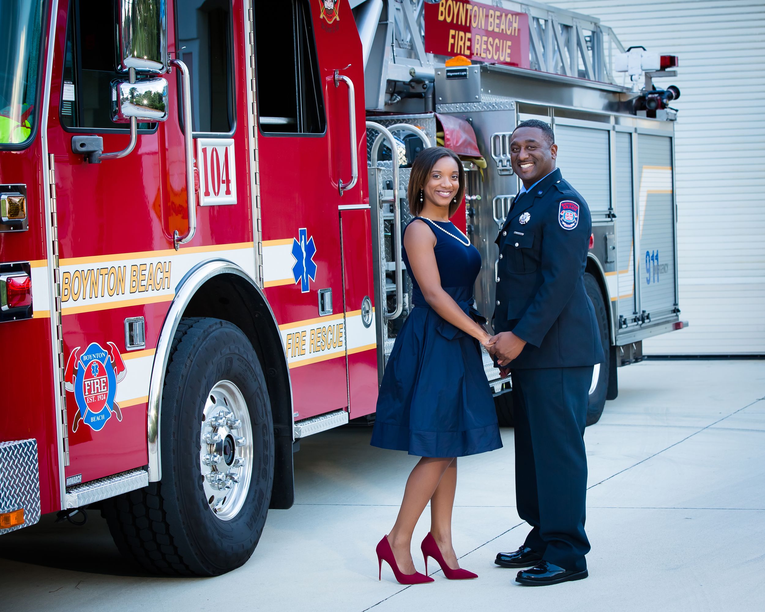 Engagement photo session with red fire truck at local fire station.