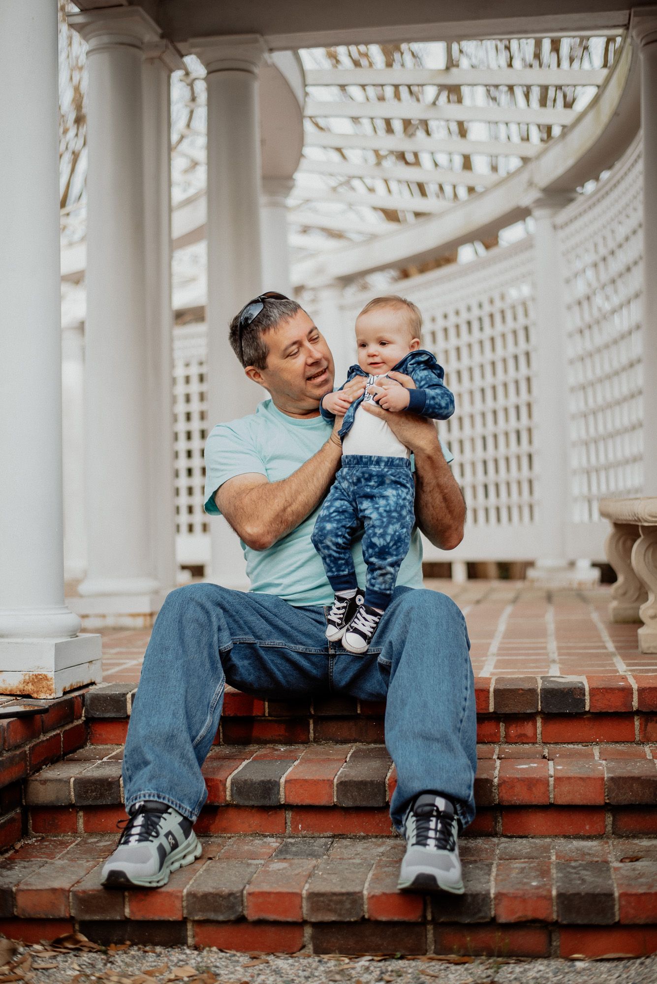 A grandpa holds his young granddaughter at Leak-Wall House in Rockingham, NC during a session with Miranda Jo Photography