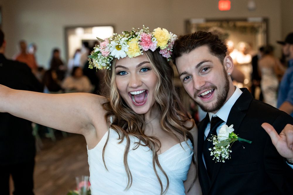 Wedding couple celebrating joyfully at their reception.