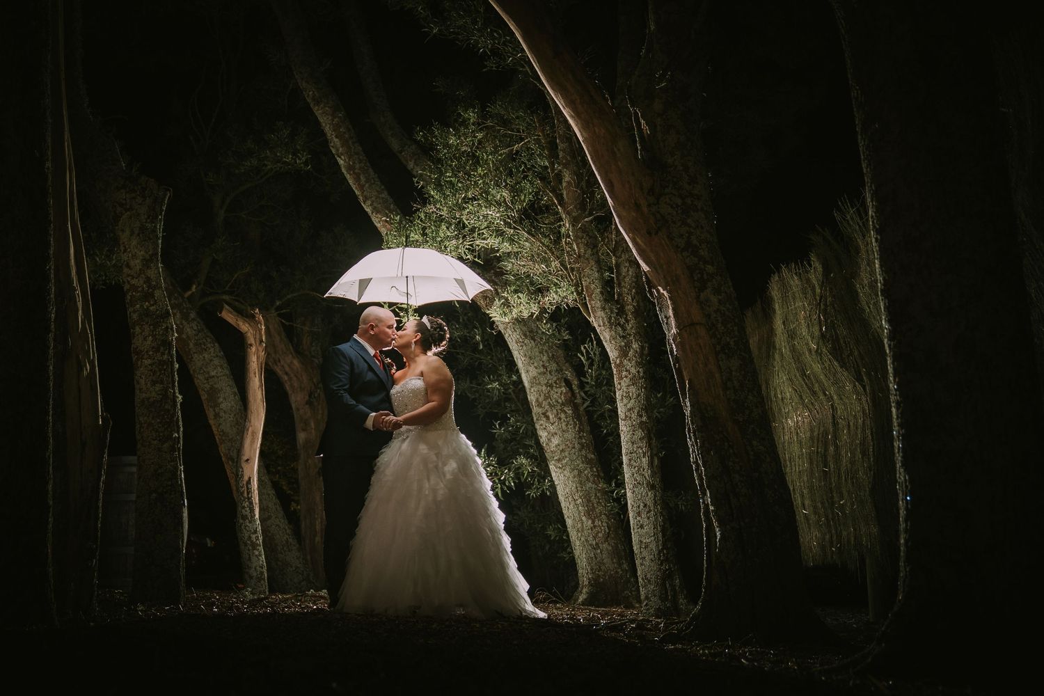 Markovina night shot, wedding with umbrella couple in trees tunnel