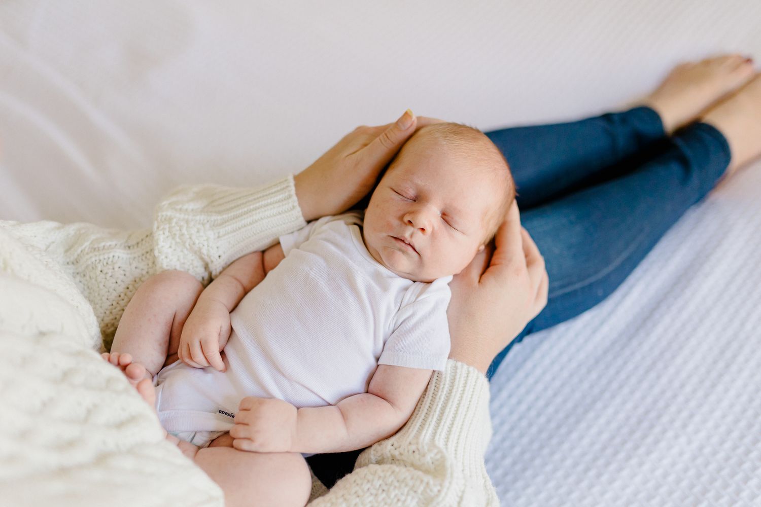newborn in carters white onesie and mom in Ann Taylor Loft sweater