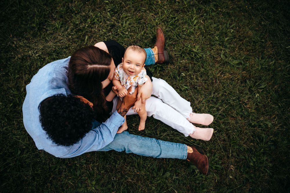 Casual candid shots of people lying in grass during a playful outdoor photo session.