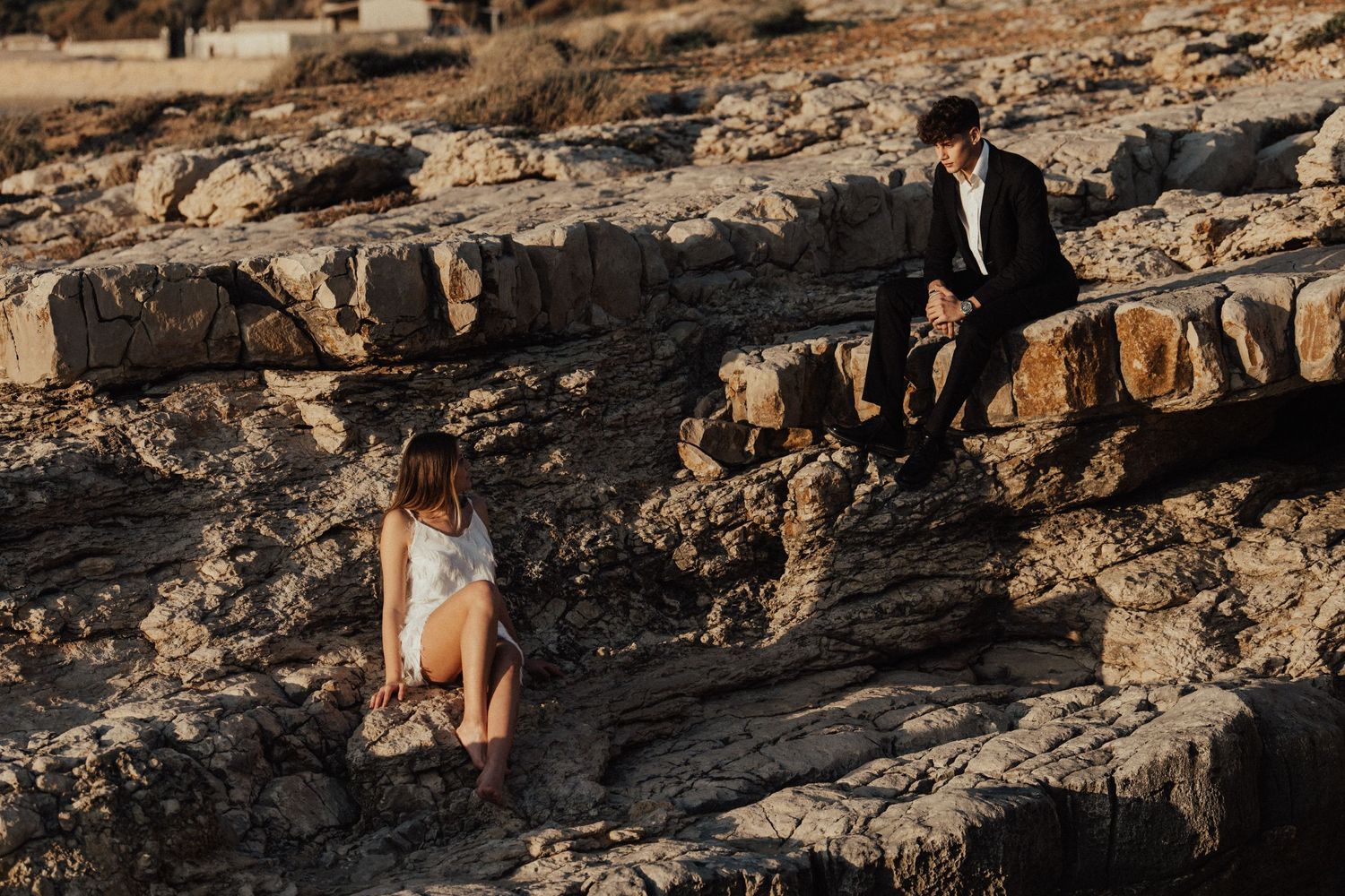 Wedding photography session on dramatic rocky seaside cliffs.