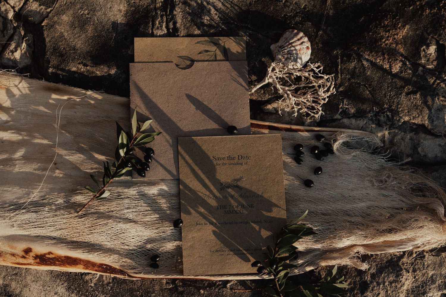 Rustic wedding details and decor arranged on natural stone surfaces.