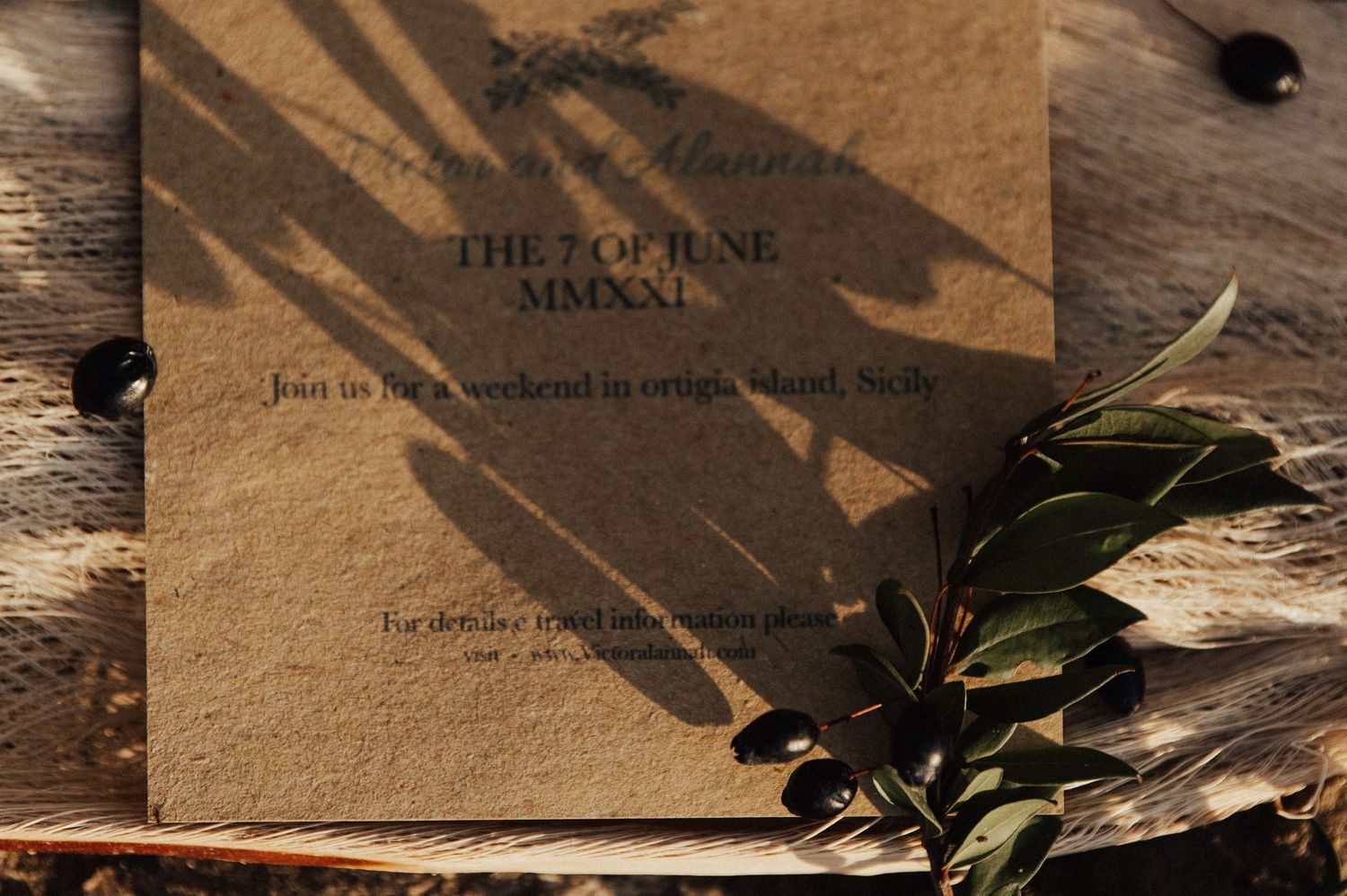 Wedding invitation suite with natural shadows and greenery accents.