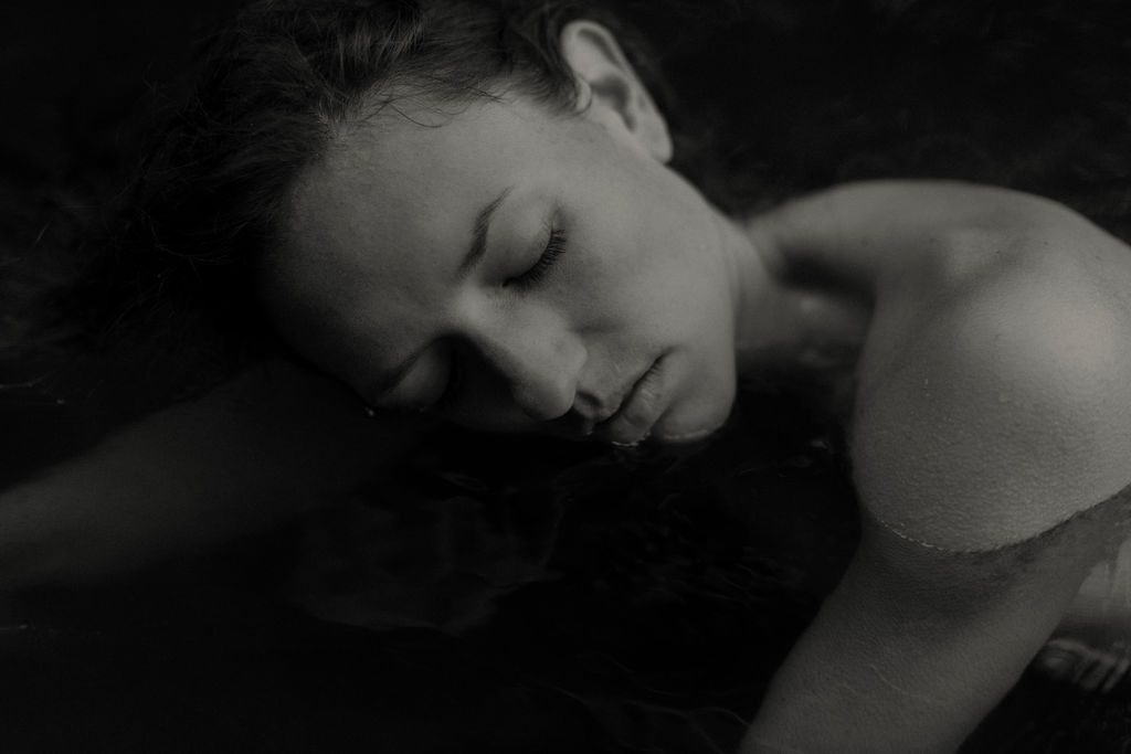 Dramatic black and white close-up portrait in low key lighting.