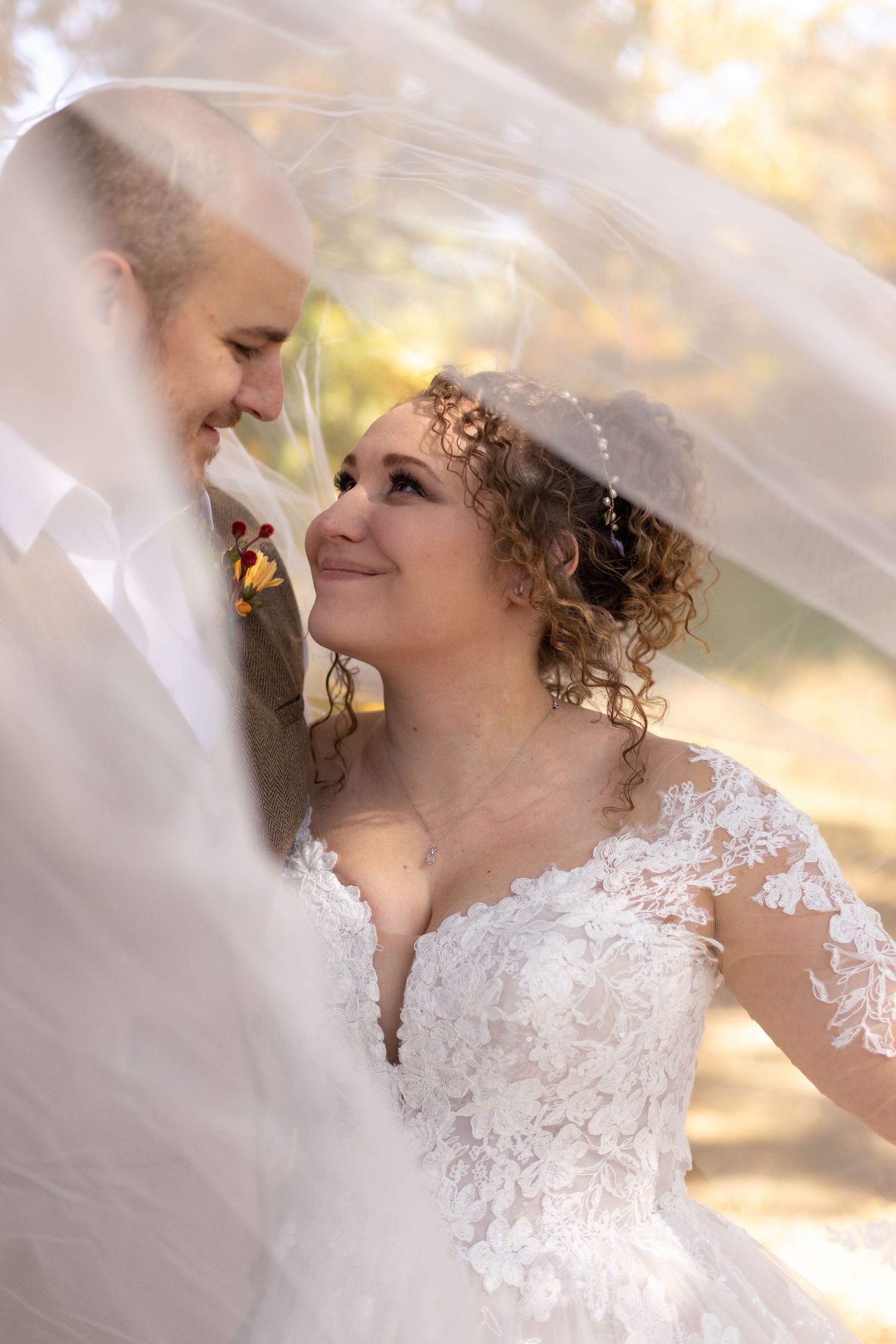 A through-the-veil shot of a soon-to-be married couple at their Illinois winery venue of choice.