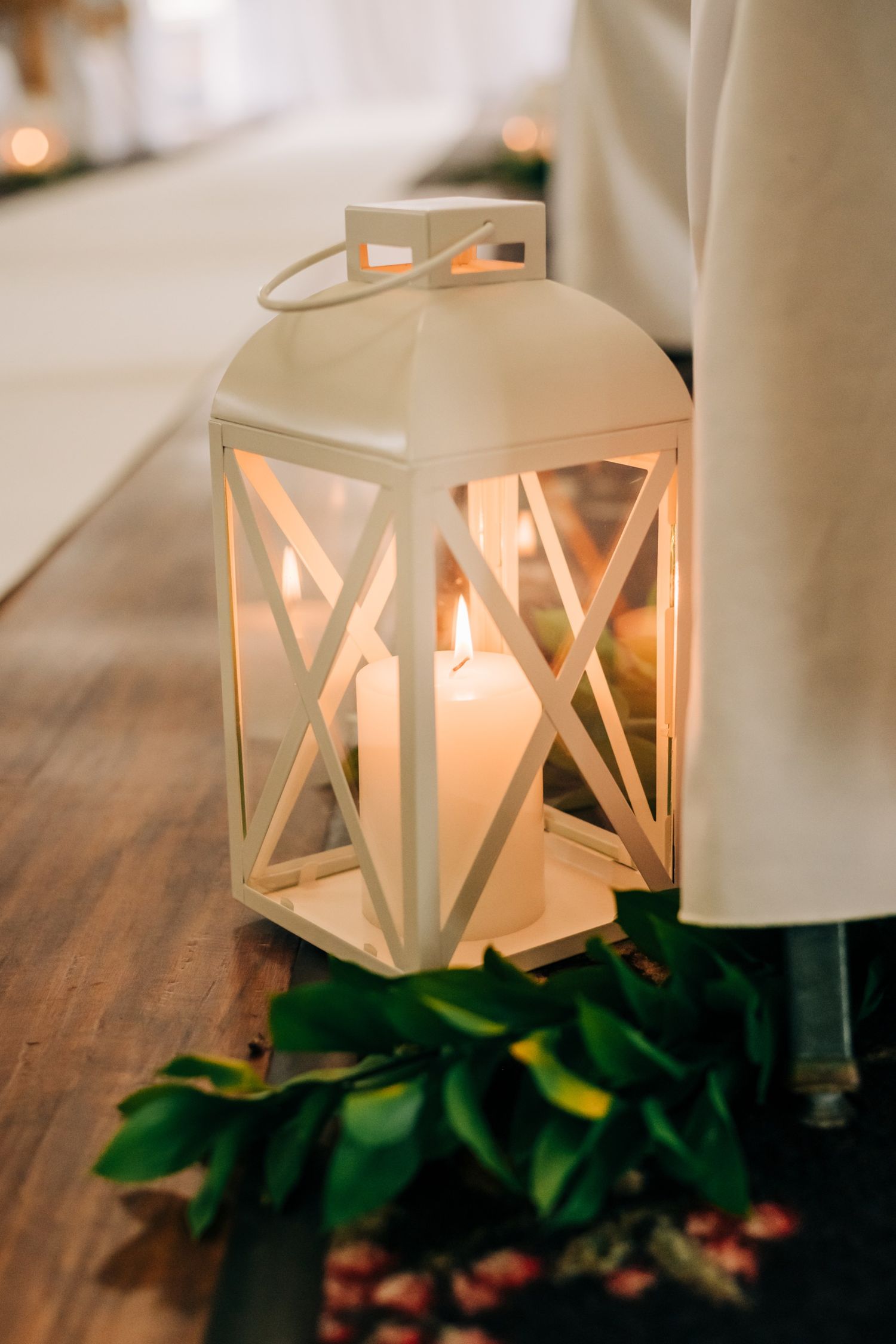 close up photo of white lantern with burning candle inside