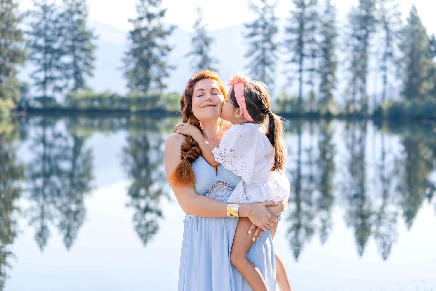 little girl kissing mom