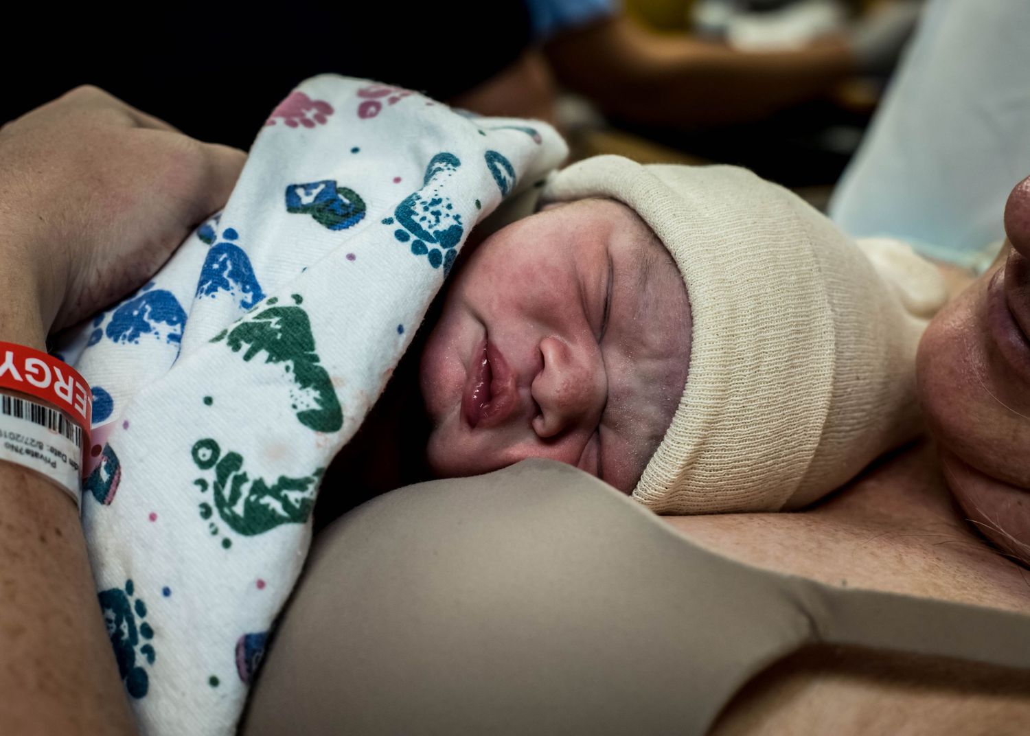 Newborn baby boy being held by his mom just minutes after birth in Sioux City, IA.