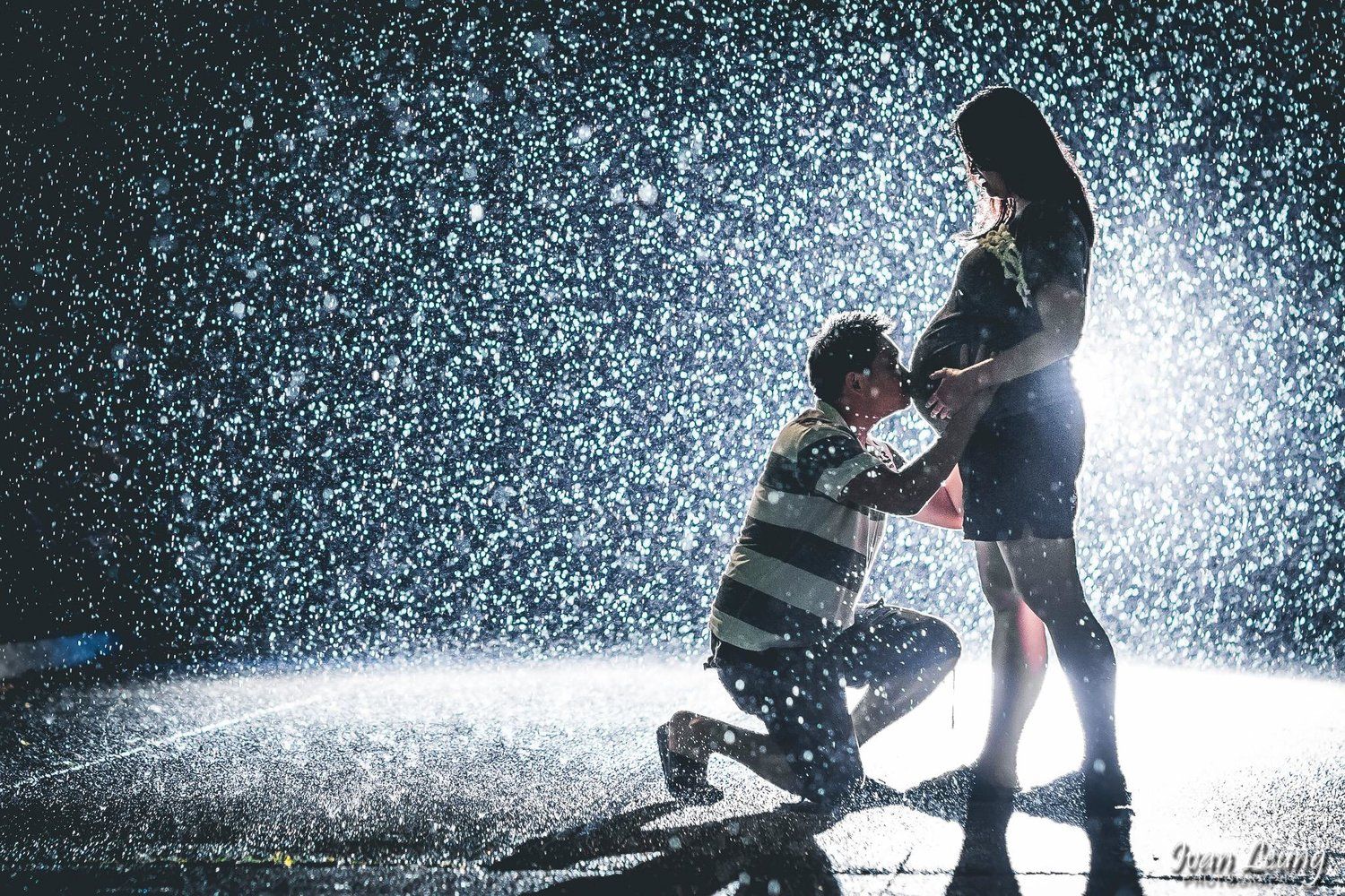 Creative backlit Maternity couple in the rain