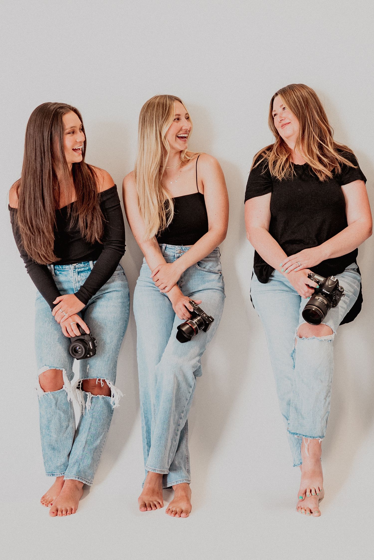 Creative women photographers smiling at each other