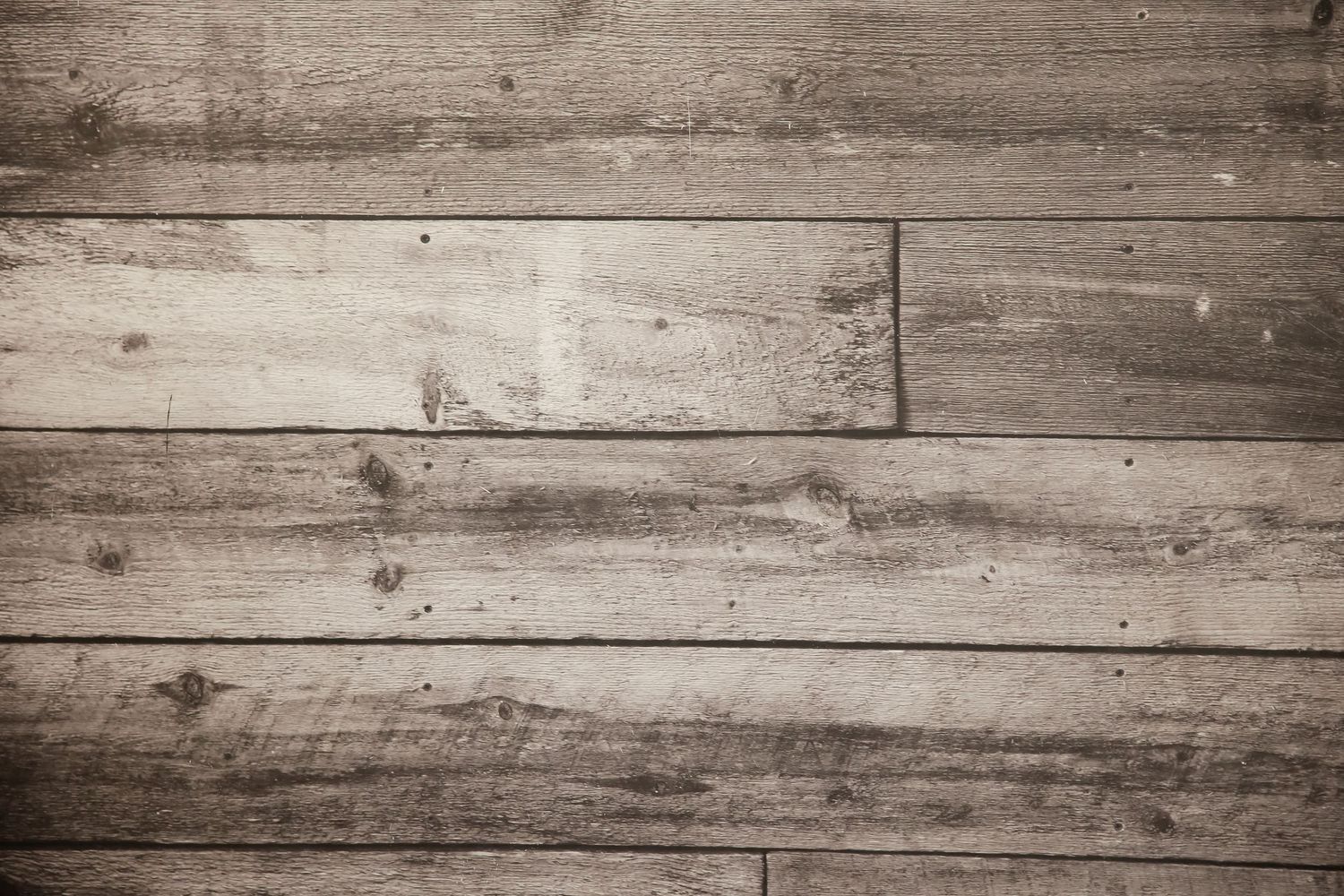 Rustic wooden planks with weathered grain texture in warm brown tones create a natural background surface.