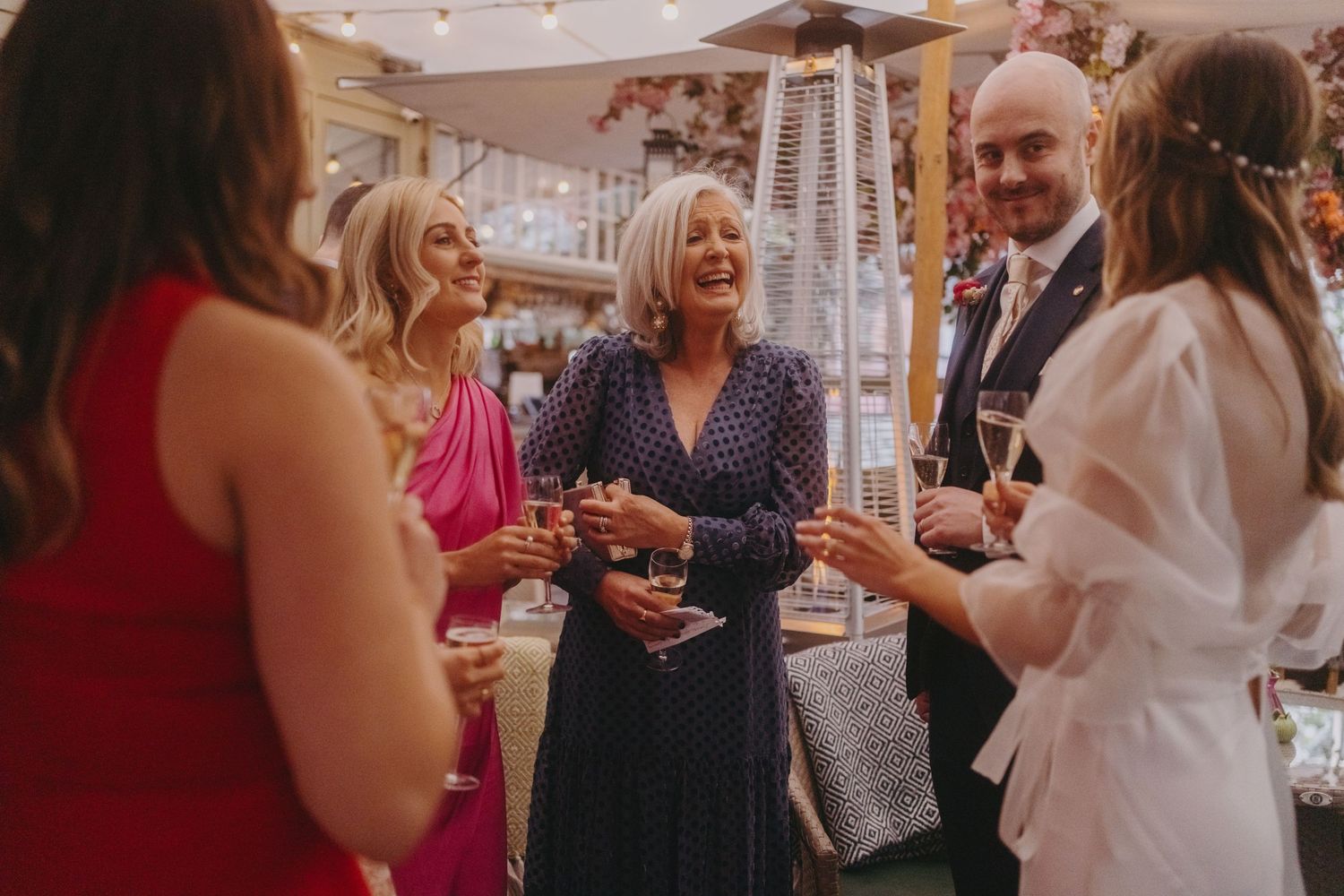 Wedding celebration features guests mingling during an elegant indoor reception.