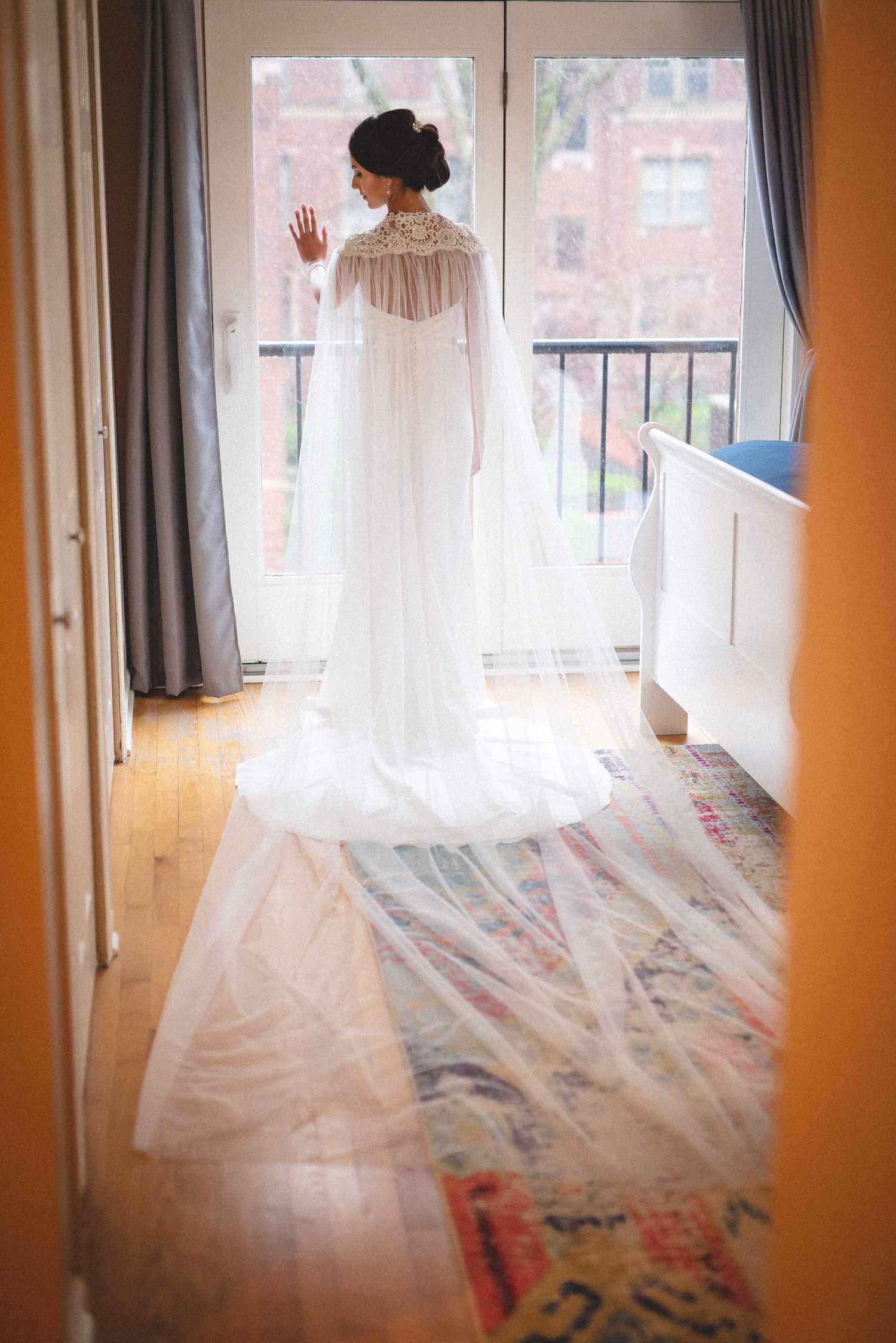 Bride's introspective moment: Clad in white, she gazes out the window, anticipation and beauty blending, before her wedd
