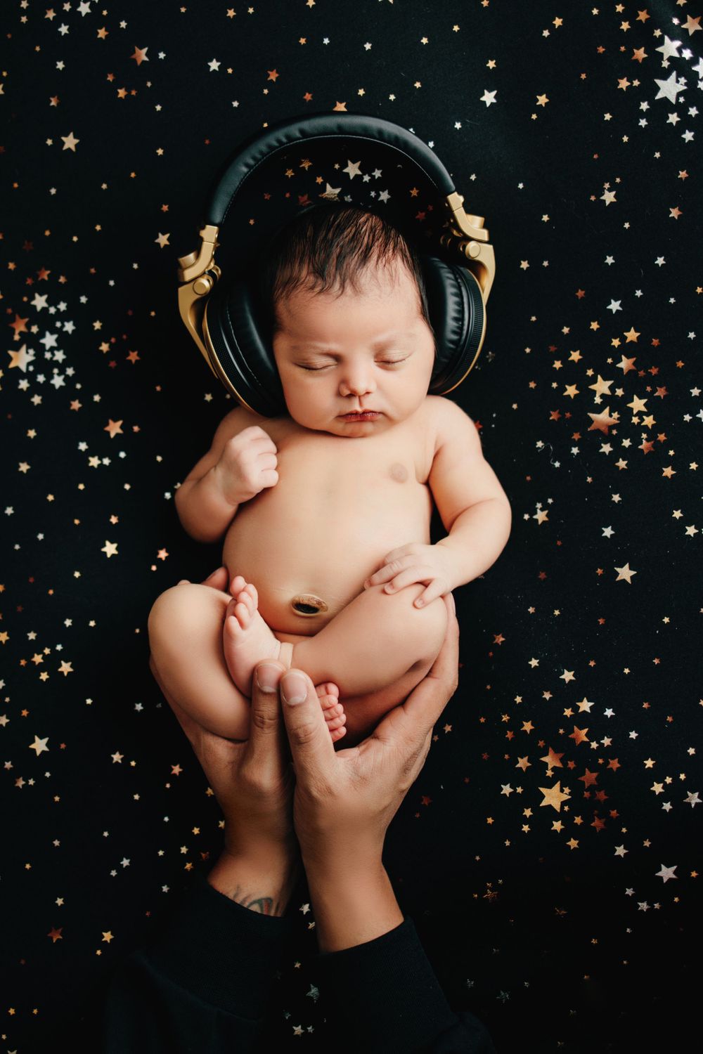 baby wearing headphones tampa fl newborn photo shoot
