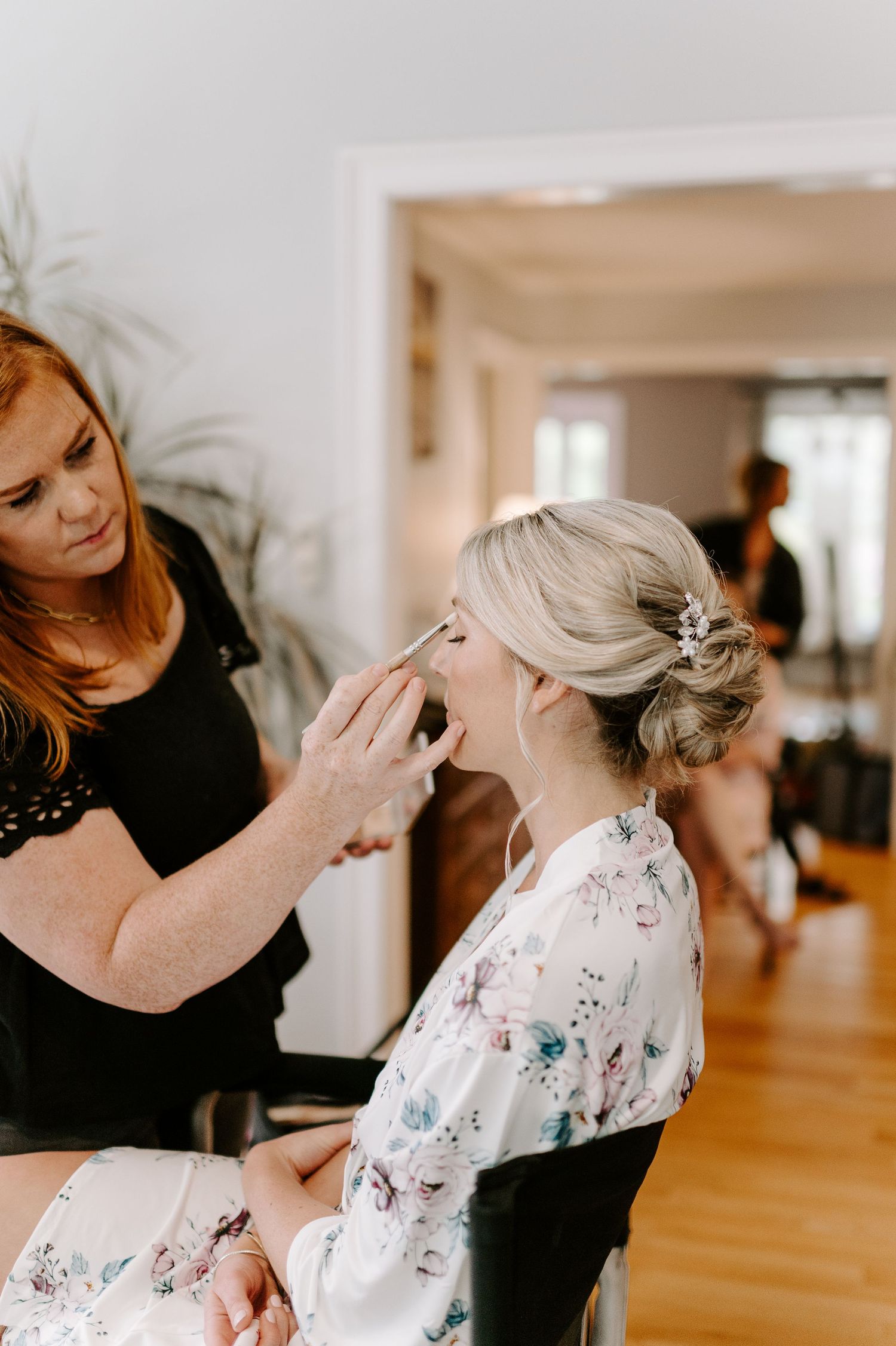 Wedding preparation scene showing final touches being added to bridal styling.