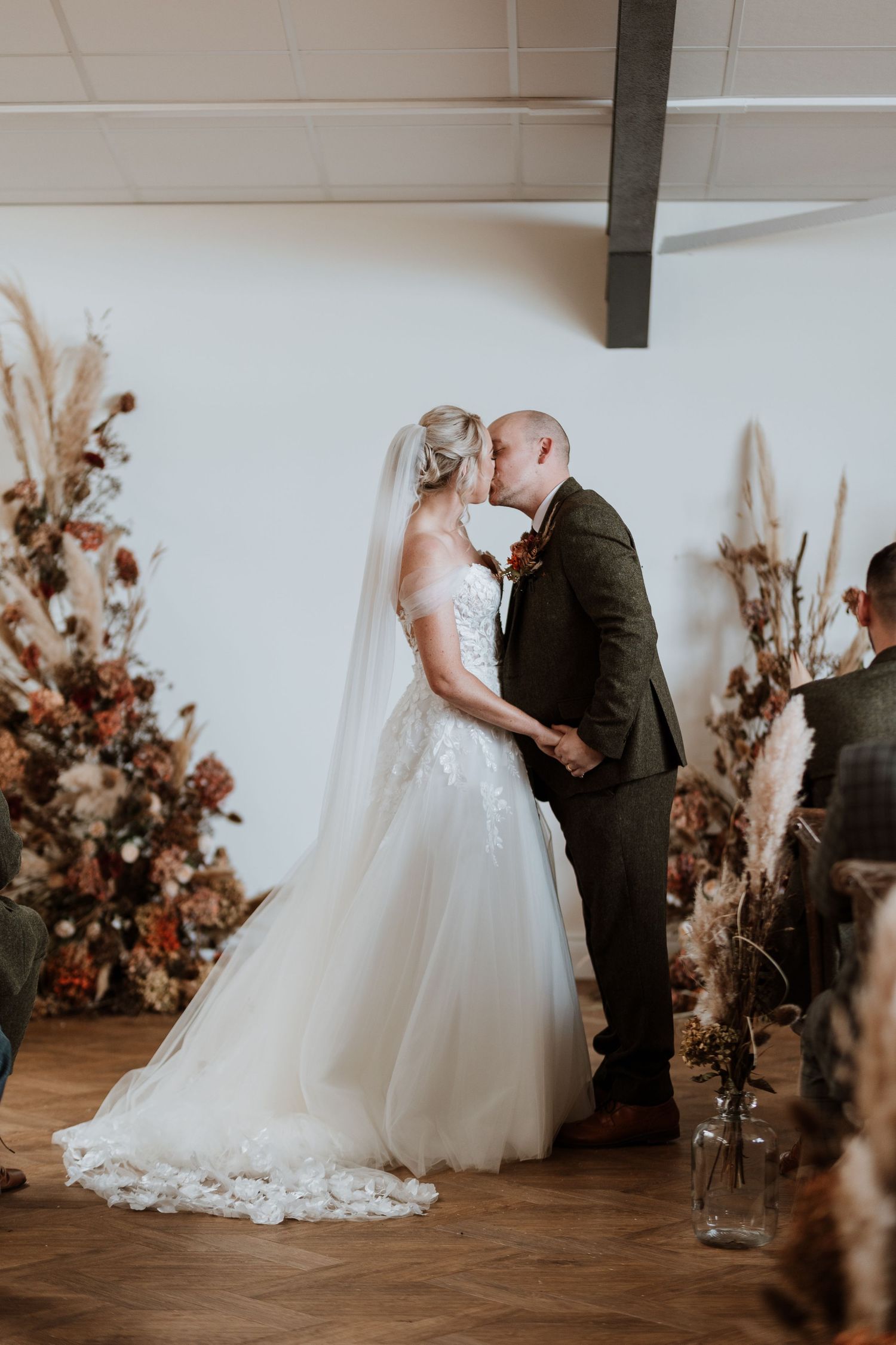 Wedding photographer at Malt House Barns capturing first kiss for Autumn Wedding