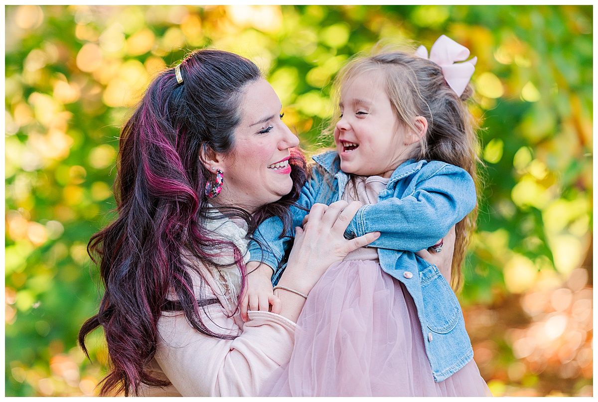 Mother and daughter smile at each other in cute photo at Holliday Park Indianapolis Indiana during Family Photography