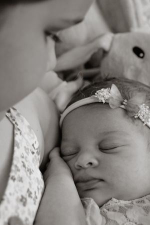 Black and white portrait of sleeping newborn with delicate lace details.