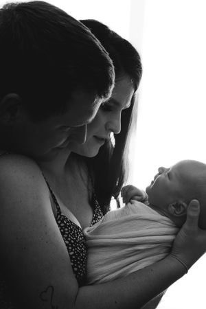 Intimate black and white portrait series showing tender moments and connection.