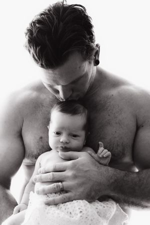 Black and white photo series showing tender moments between parent and infant in intimate close-up shots.