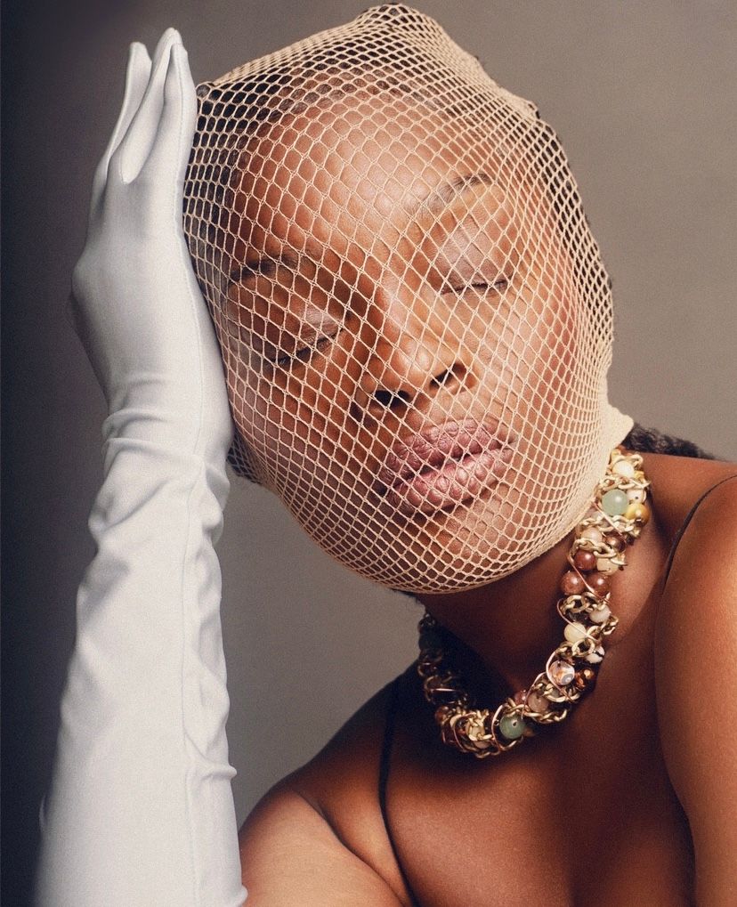 Elegant beauty shot featuring fishnet veil, pearl necklace, and long white gloves.