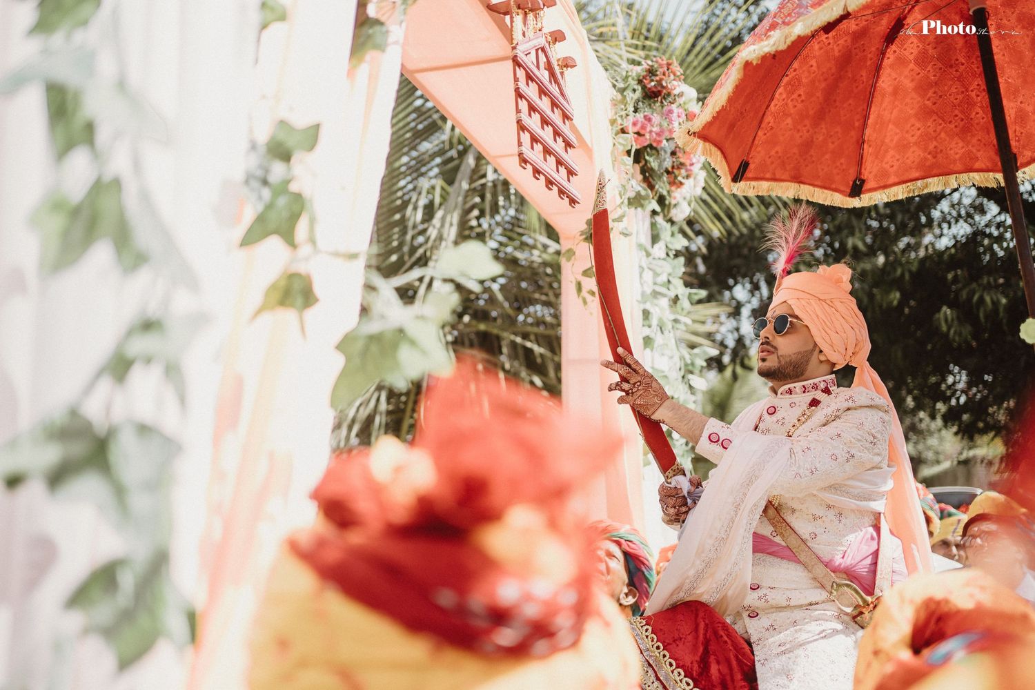 Red umbrellas and decorative elements create a festive atmosphere at outdoor celebration.