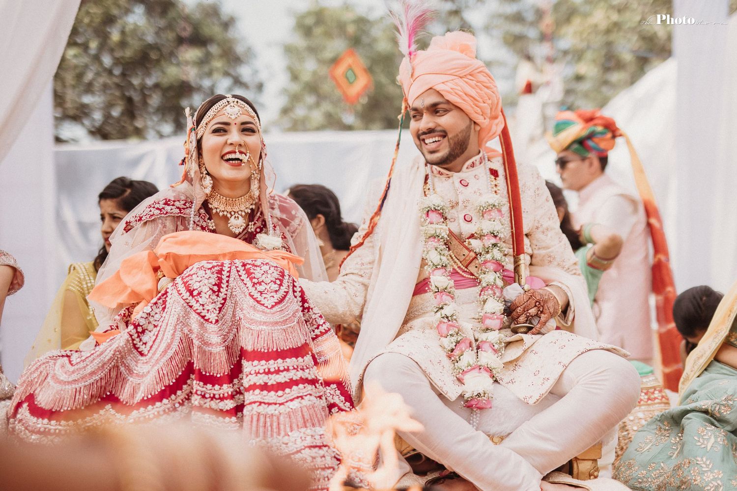 Candid moments from an Indian wedding ceremony with decorative white draping.