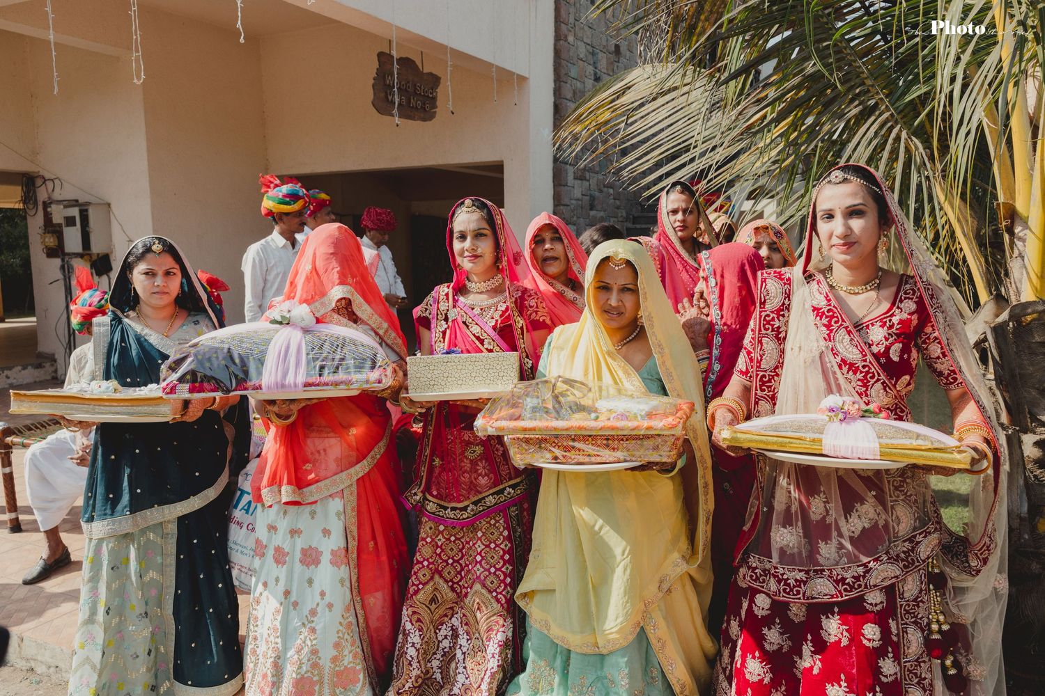 Guests in colorful traditional attire gather at an outdoor celebration event.