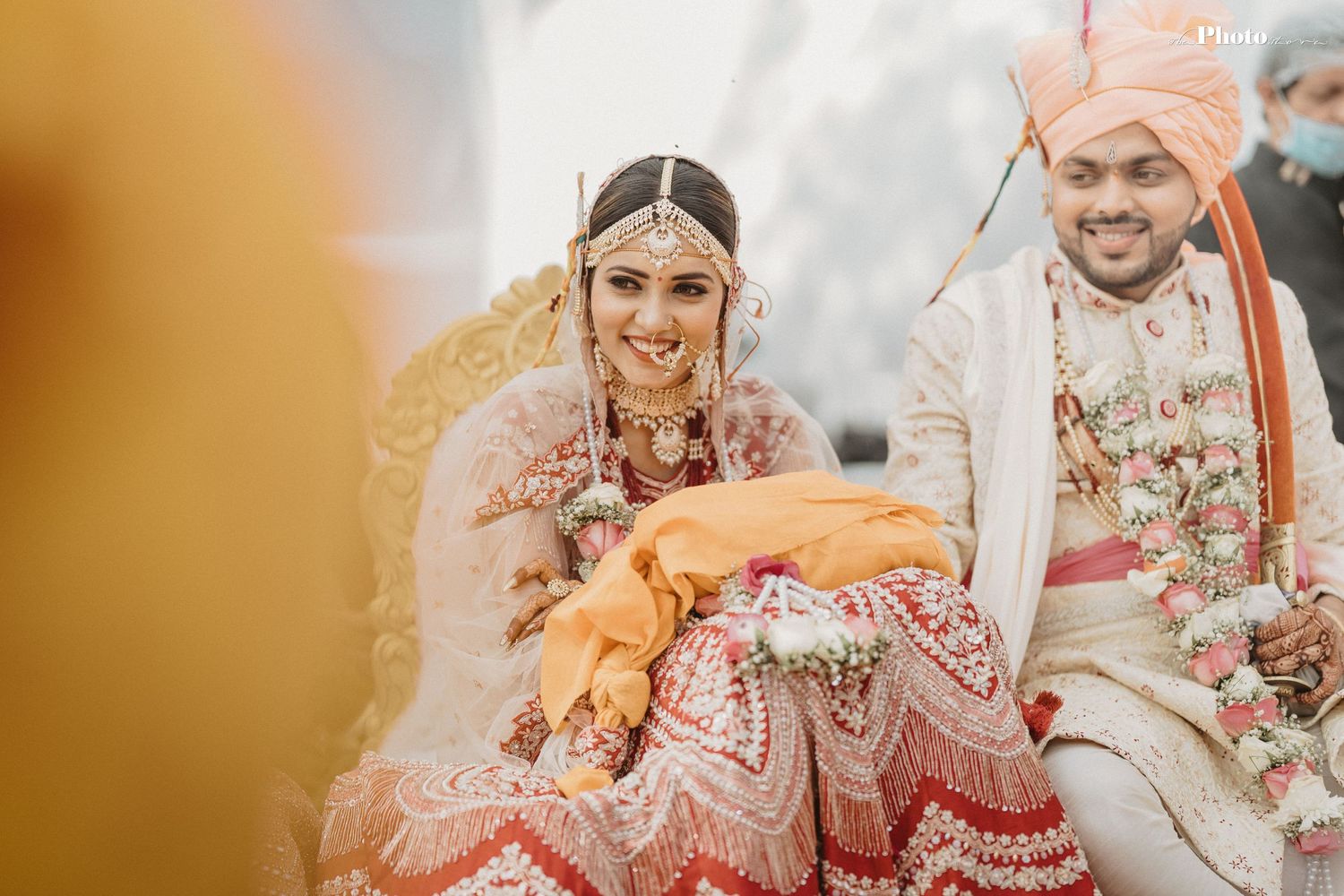 Candid moments from an Indian wedding ceremony with warm lighting and traditional outfits.