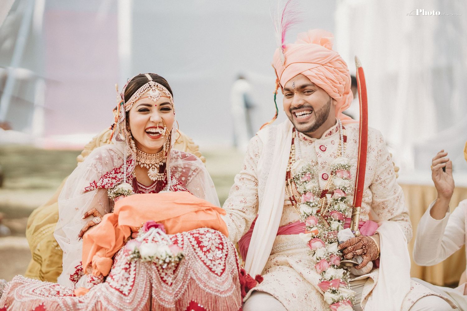 Candid celebration during an Indian wedding with traditional attire and decorations.