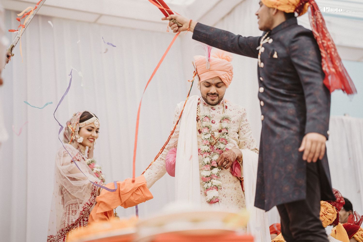 Celebratory moments during an Indian wedding with guests participating in traditional customs.