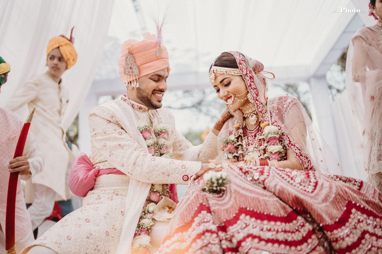 Beautiful Indian wedding ceremony with traditional pink and white decorative elements.
