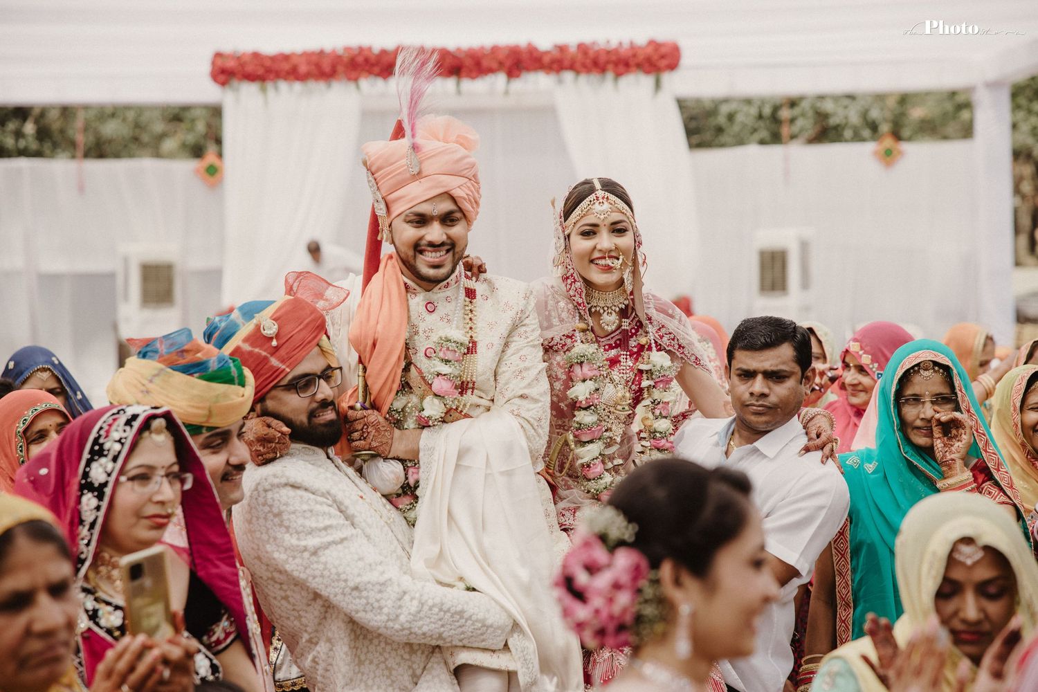 Wedding celebration showing guests and decorations during traditional Indian ceremony.