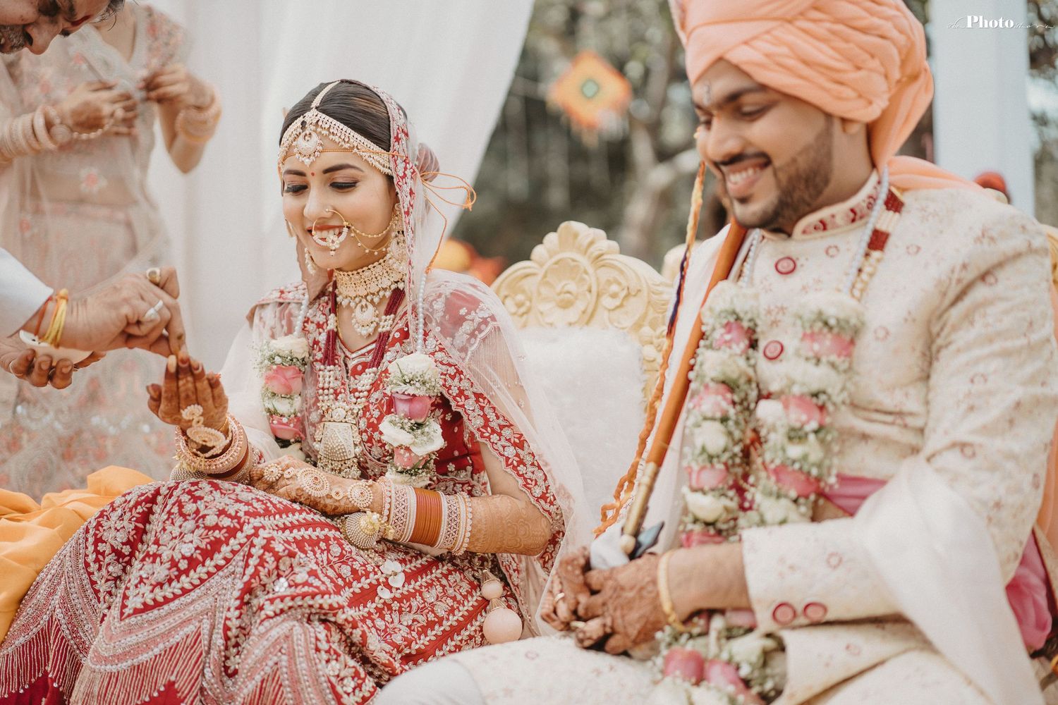 Candid moments from a traditional Indian wedding with pink and cream color scheme.