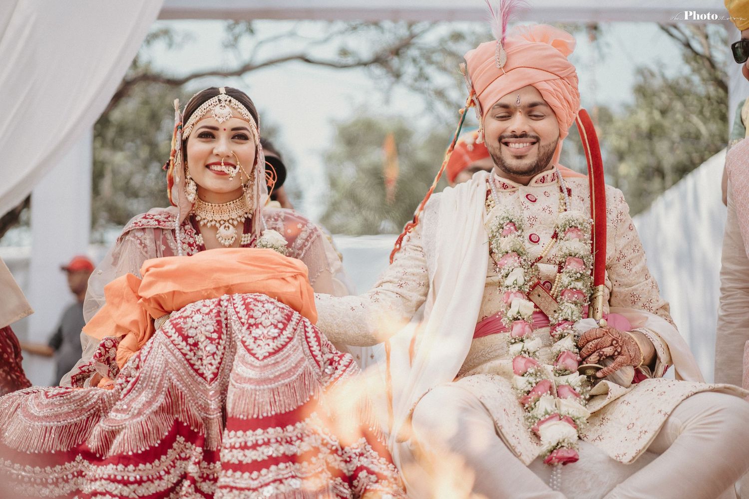 Intimate moments from an Indian wedding ceremony with traditional outfits and decor.