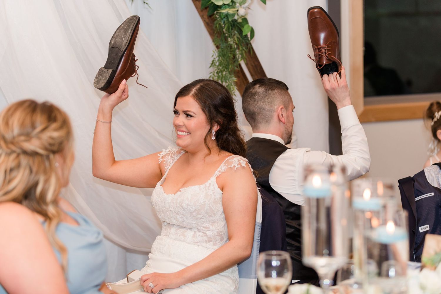 Wedding party members sharing emotional moments during reception toasts.