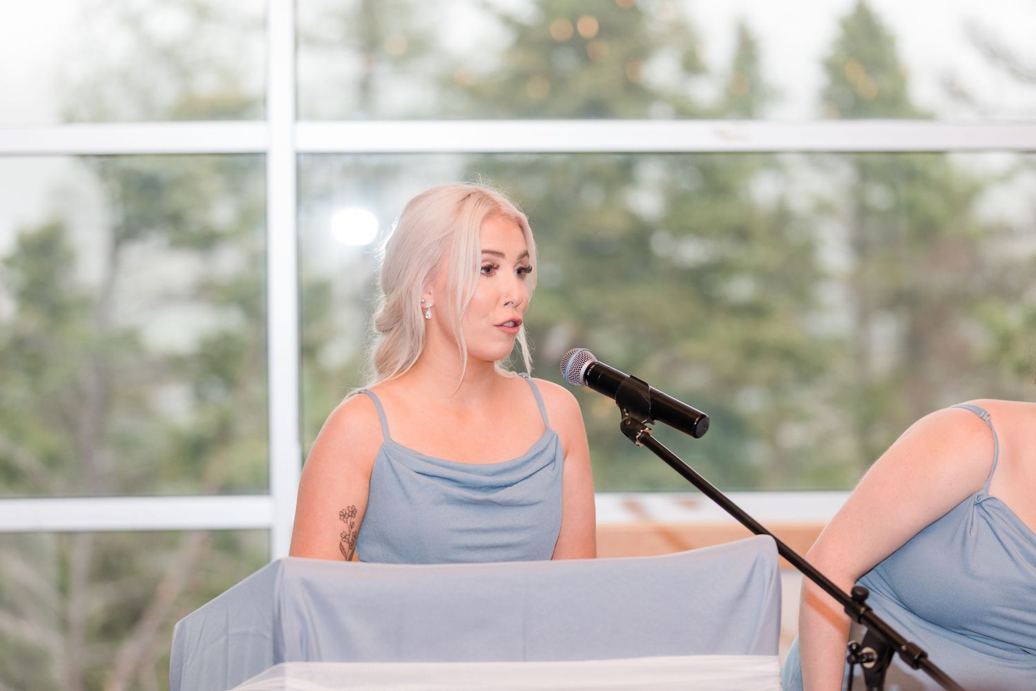 Wedding reception speeches and toasts being given at an elegant indoor venue.