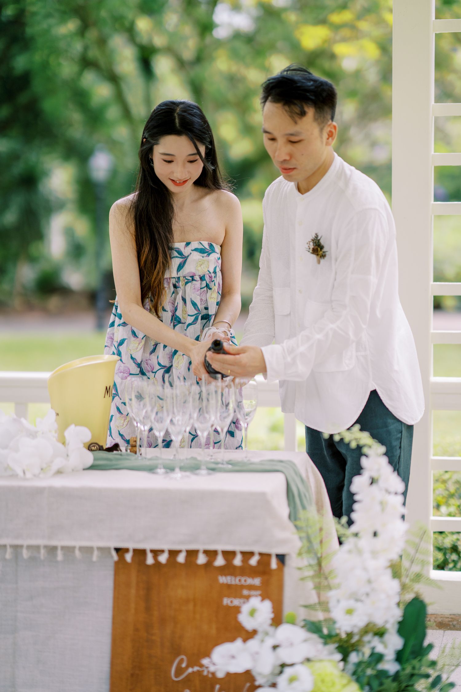 Romantic champagne service in a garden gazebo with floral decorations.