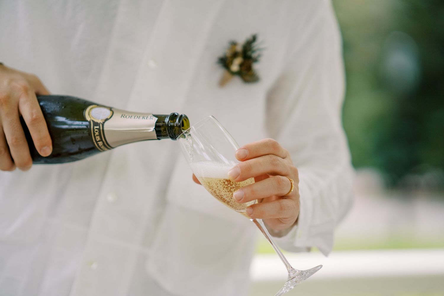 Champagne bottles being opened during an elegant outdoor celebration.