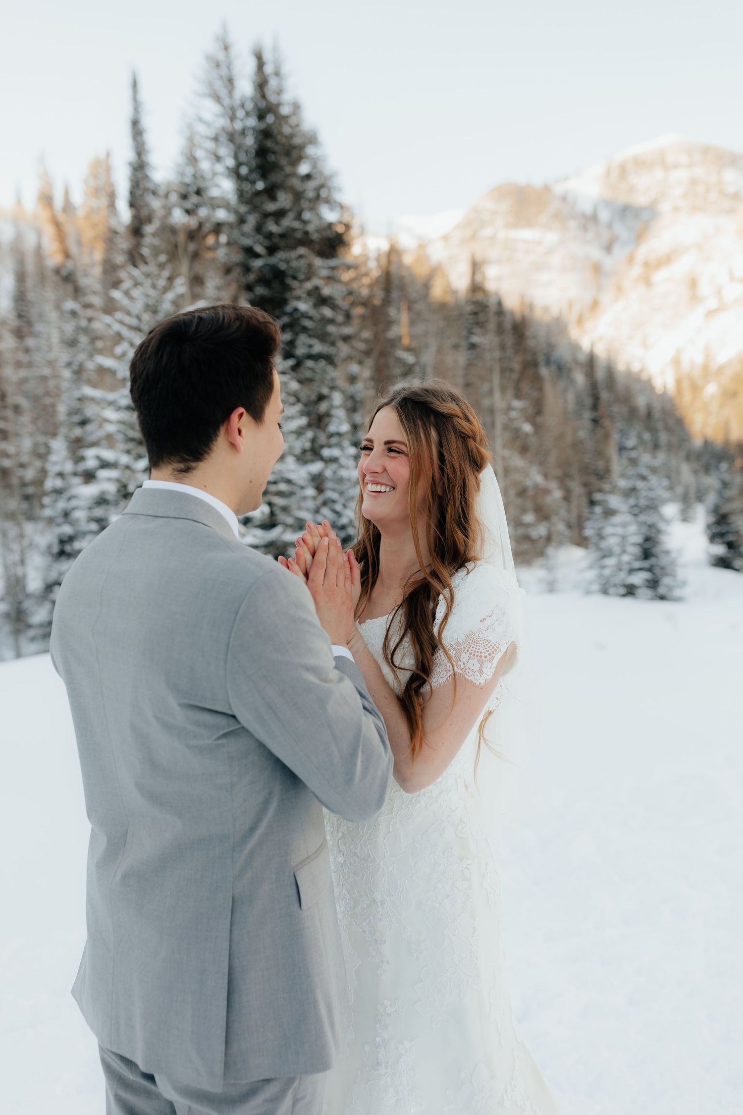 Groom warming brides hands
