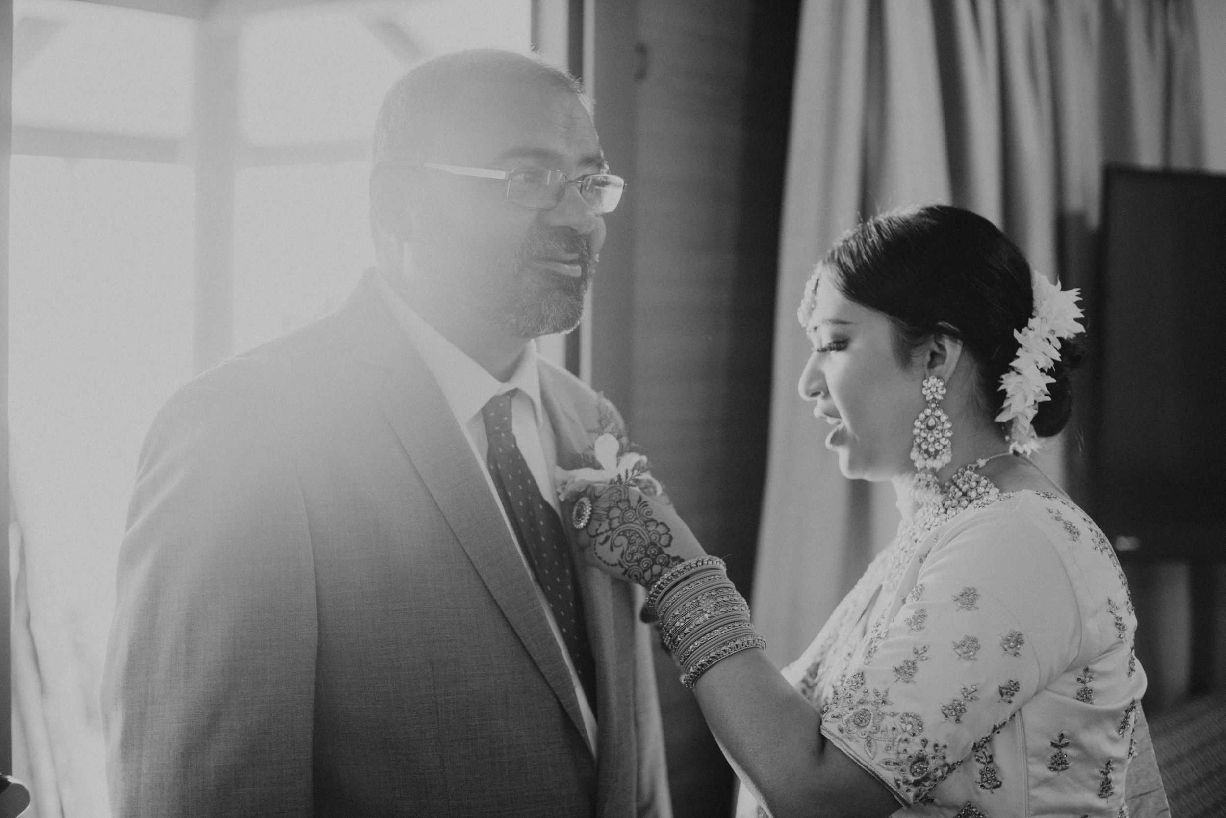 Black and white wedding photograph in an intimate indoor setting.